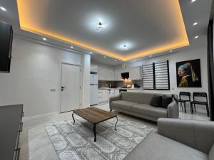 a living room with a couch and a table at minta suits in Kemer