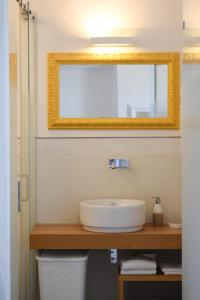 a bathroom with a sink and a mirror at Ganimede Centro Storico in Sperlonga