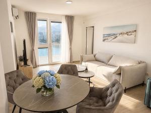 a living room with a table and a couch at Panorama Chill in Rafailovici