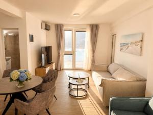 a living room with a couch and a table at Panorama Chill in Rafailovici