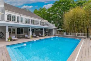 a swimming pool in front of a house at Southampton Beauty in Southampton