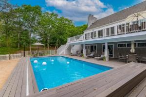 a swimming pool in front of a house at Southampton Beauty in Southampton