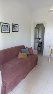 a living room with a couch and a table at Villa Dallas-Beach,Bike & Gym in Vourvourou