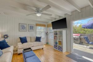 a living room with a couch and a ceiling fan at The Surfcomber Multi-Residence Home in Ocean Bay Park