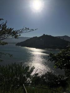 a view of a body of water with the sun at Na Boca do Jacaré in Caraguatatuba