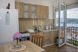 a kitchen with a table and a view of the ocean at Lala in Herceg-Novi