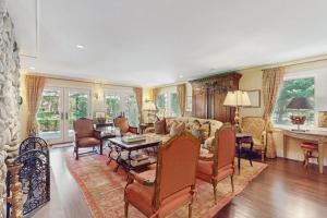 a living room with a couch and a table and chairs at Cedar Crest Retreat in Southampton