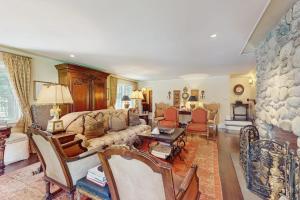 a living room with a couch and a stone wall at Cedar Crest Retreat in Southampton +30 photos