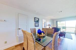 a dining room with a glass table and chairs at Tranquility on the Lake in Montgomery