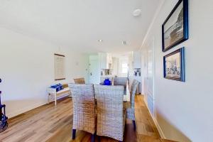a dining room with white walls and wicker chairs at Tranquility on the Lake in Montgomery
