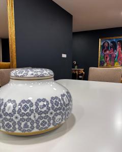 a blue and white vase sitting on top of a table at Royal Galla Apartment in Macedo de Cavaleiros