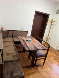 a dining table and a couch in a living room at Amos 1 in Paraćin +19 photos