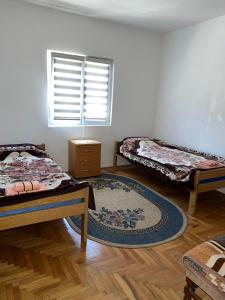 a room with three beds and a window at Amos 1 in Paraćin