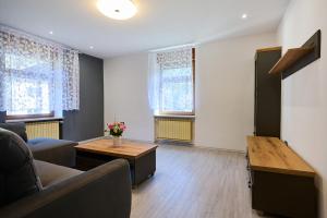 a living room with a couch and a table at Luče Holiday Apartment in Luče