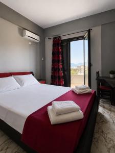 a bedroom with a large bed with towels on it at Vila New Ksamil in Ksamil