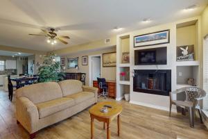 a living room with a couch and a table at Mariner Village 108 in Seabrook