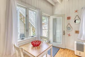 a dining room with a table and a window at The Surfcomber Unit 2 in Ocean Bay Park