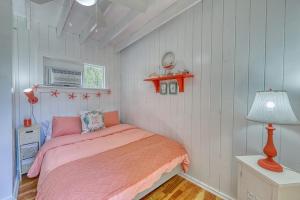 a bedroom with a pink bed and a lamp at The Surfcomber Unit 2 in Ocean Bay Park