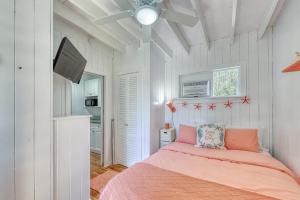 a bedroom with a bed and a flat screen tv at The Surfcomber Unit 2 in Ocean Bay Park