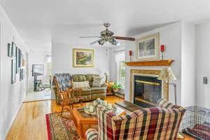 a living room with a couch and a fireplace at Minnehaha Marvel in Southold