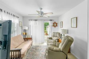 a living room with a couch and a ceiling fan at Minnehaha Marvel in Southold