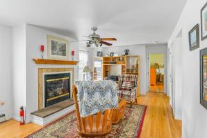 a living room with a chair and a fireplace at Minnehaha Marvel in Southold