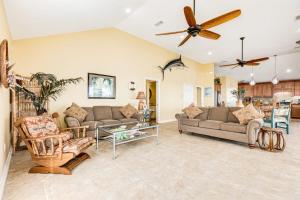a living room with two couches and a ceiling fan at Reel Paradise in Bacliff