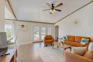 a living room with a couch and a ceiling fan at Waterfront Hideaway in La Marque