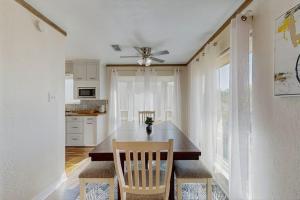 a kitchen with a dining table and a ceiling fan at Waterfront Hideaway in La Marque
