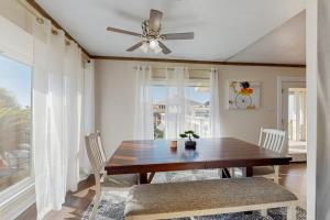 a dining room with a table and a ceiling fan at Waterfront Hideaway in La Marque