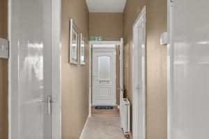 a hallway with a white door in a room at Home in Perth and Kinross in Coupar Angus