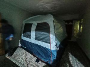 a tent in the corner of a room at Nomad's Nest Camp in Wāmpor