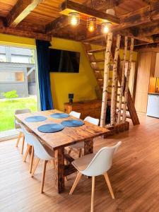 a dining room with a wooden table and chairs at 10 osobowy Bania House Okuninka rowerek wodny jacuzzi sauna 1200 m do centrum Okuninki 6 km do Włodawy in Włodawa