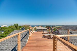 a wooden deck with benches on top of a roof at Poolside Chic by the Sea in Ocean Bay Park