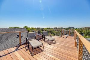 a wooden deck with chairs on a roof at Poolside Chic by the Sea in Ocean Bay Park