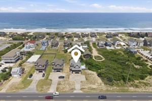 an aerial view of a house next to the ocean at 5471 - Resting Beach Face in Nags Head