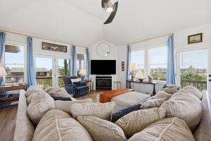 a living room with a couch and a tv at 5471 - Resting Beach Face in Nags Head