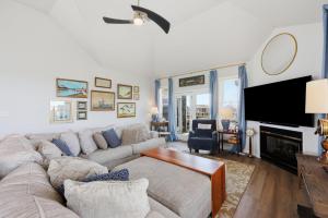 a living room with a couch and a fireplace at 5471 - Resting Beach Face in Nags Head