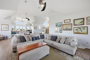 a living room with a couch and a table at 5471 - Resting Beach Face in Nags Head