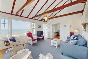 a living room with a blue couch and chairs at North Fork Waterfront Gem in East Marion