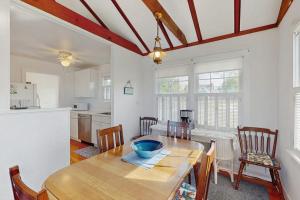 a kitchen and dining room with a wooden table and chairs at North Fork Waterfront Gem in East Marion