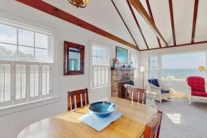 a dining room with a table with a bowl on it at North Fork Waterfront Gem in East Marion