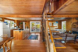 a kitchen and living room in a log cabin at Seaside Escape on Huron in Ocean Beach