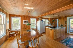 a kitchen and dining room with a wooden ceiling at Seaside Escape on Huron in Ocean Beach +17 photos