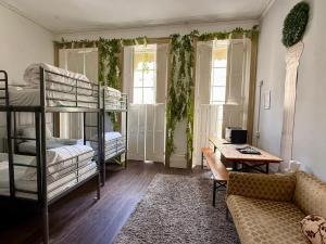 a living room with bunk beds and a couch at Hangover Hotel - Seafront 8 in Brighton & Hove