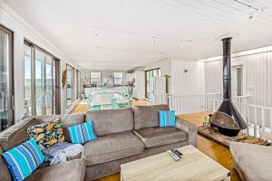 a living room with a couch and a fireplace at Robbins Rest Retreat in Ocean Beach