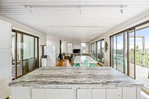 a large kitchen with a large island in a room with windows at Robbins Rest Retreat in Ocean Beach