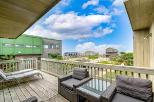 a balcony with two chairs and a couch on it at Robbins Rest Retreat in Ocean Beach