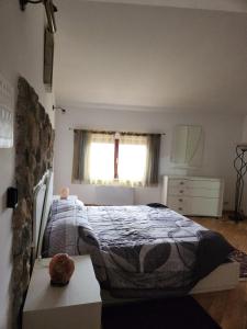 a bedroom with a bed and a window at Il Pozzo dei desideri Shabby in Spilimbergo