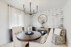 a dining room with a table and a mirror at Lake Grove Retreat in Conroe +11 photos